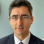 A close headshot of Paul Imre in glasses and a suit, presenting the AI, data and privacy course instructor on Nexus Jump.